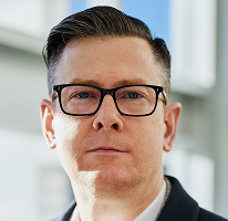 Portrait of Alexander Hughes, executive and chief officer of a cryptocurrency trading company